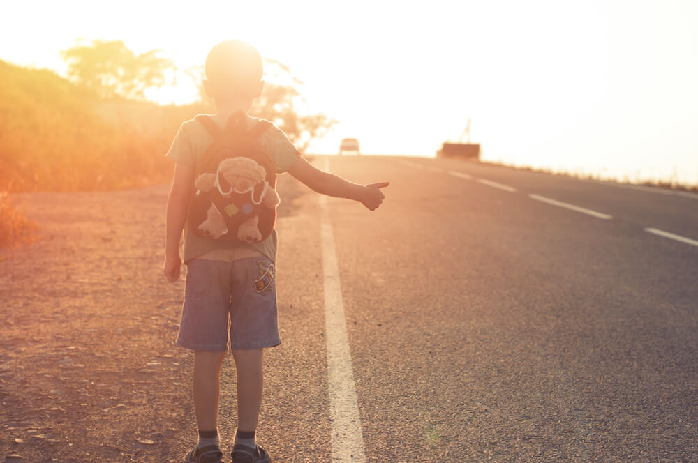 Little child hitchhiking